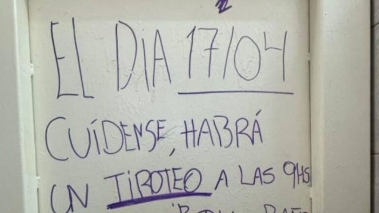 Adolescentes con mochilas frente a una escuela con policías