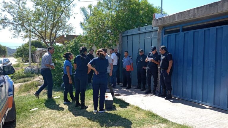 Peritos y policías afuera de la casa de Rojas